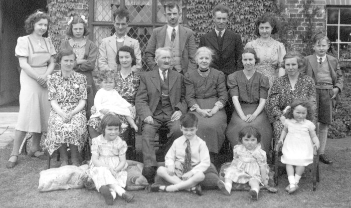 Joe and Etta were married at Capel St Mary on 5 June 1892, and celebrated their Golden Wedding on Whit-Monday 25 May 1942 at The Fens.   Standing: Marjorie, Beulah, George, Arthur, Cecil, Noreen, Aubrey; Seated: Edie, Hilda with Henry, Joe, Etta, Dorothy, Grace; In front: Anne, Teddy, Susan and Vivien.  Absent was Hilda’s husband Martin on duty with the Royal Observer Corps in Bury St Edmunds